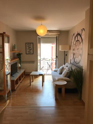 a living room with a couch and a table at Apartamentos Logroño centro, TIC TAC, wifi in Logroño