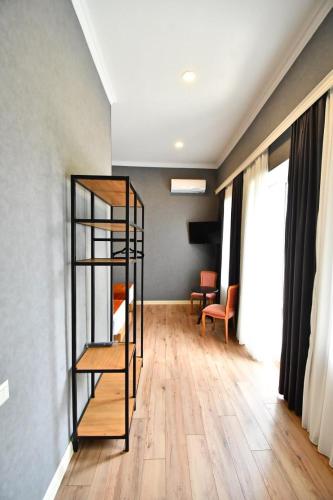 a room with a wooden floor and a glass shelf at Hotel 1887 in Kutaisi