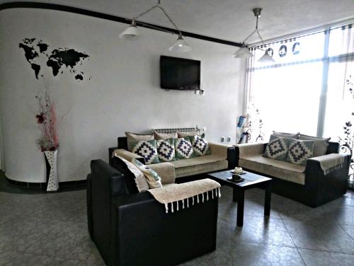 a living room with a couch and a table at Hotel Scorpion in Kru&scaron;evo