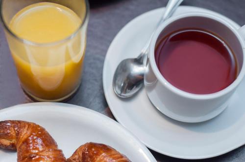 a plate with a cup of coffee and croissants on a table at Panoramic Grand - Iguazú in Puerto Iguazú