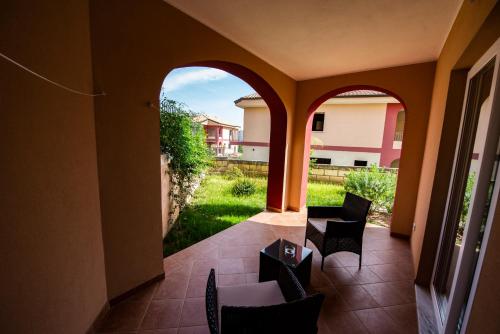 a view of a patio with chairs and a table at Aether Suites Tropea - Free Private Parking in Tropea