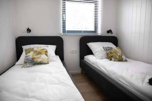 Postel nebo postele na pokoji v ubytování Słowiński Zakątek