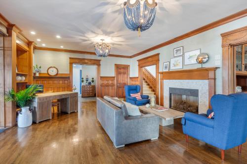 a living room with blue chairs and a fireplace at The Shore House in Narragansett
