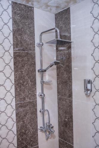 a shower with a glass door in a bathroom at Red Hotel Yerevan Center in Yerevan