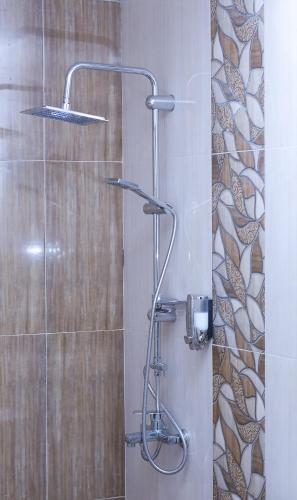 a shower with a shower head in a bathroom at Red Hotel Yerevan Center in Yerevan