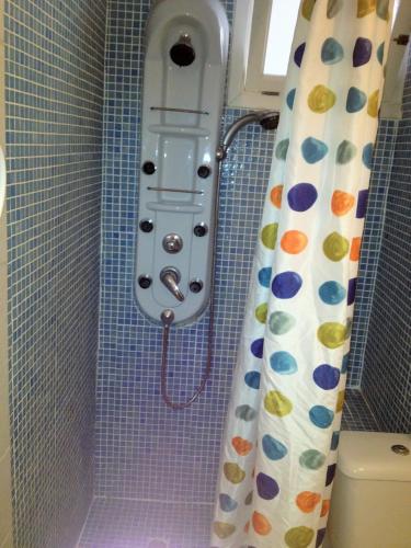 a shower in a bathroom with a shower curtain at Hostal Alce in Playa de Palma