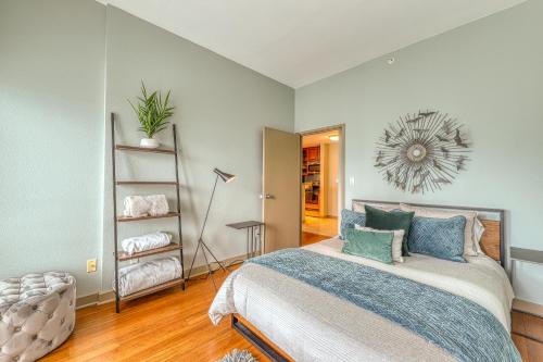 a bedroom with a large bed with blue pillows at Newmark Tower in Seattle