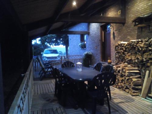 a table and chairs on a patio with a building at Votre Horizon in Aywaille