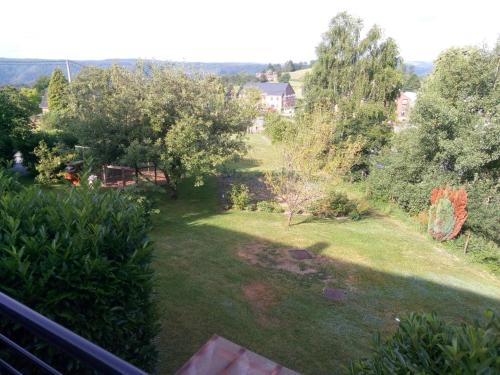 a view of a garden from the balcony of a house at Votre Horizon in Aywaille