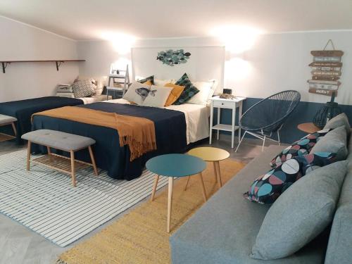 a bedroom with a bed and a couch at IL CUCCO B&B in Ginosa Marina