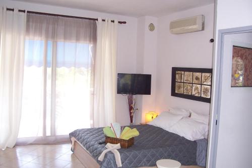 a bedroom with a bed with a book on it at Christina's House in Iraklitsa