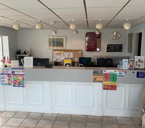 a counter in a restaurant with signs on it at Roman Holiday Resort in North Wildwood