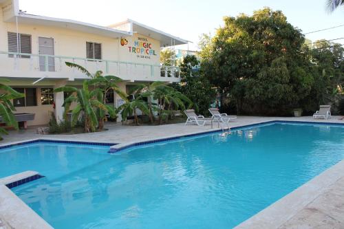 a large blue swimming pool in front of a hotel at Hotel Magic Tropical in Boca Chica