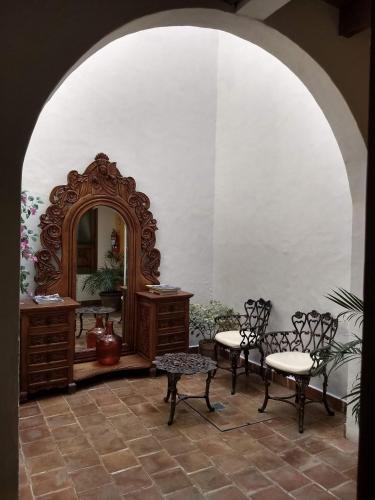 a room with a mirror and two chairs and a table at Hotel Grand Maria in San Cristóbal de Las Casas