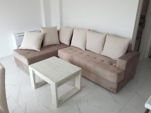 a living room with a couch and a coffee table at Olea in Tivat