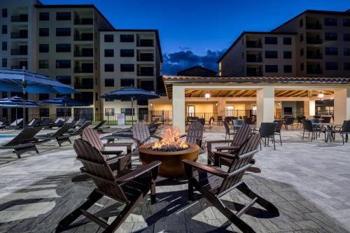 a group of chairs and a fire pit in a patio at Siena at Bella Collina in Montverde