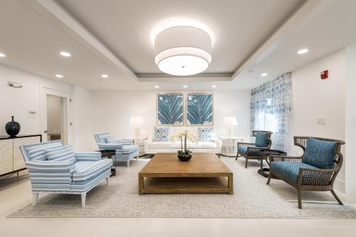 a living room with chairs and a couch and a table at Siena at Bella Collina in Montverde