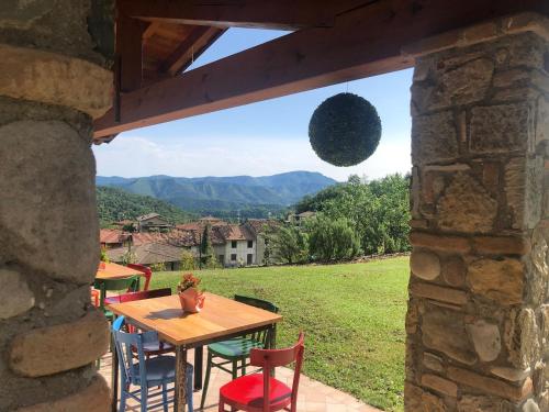 a table and chairs on a patio with a view at Alla Vecchia Contrada B&B in Provaglio Val Sabbia