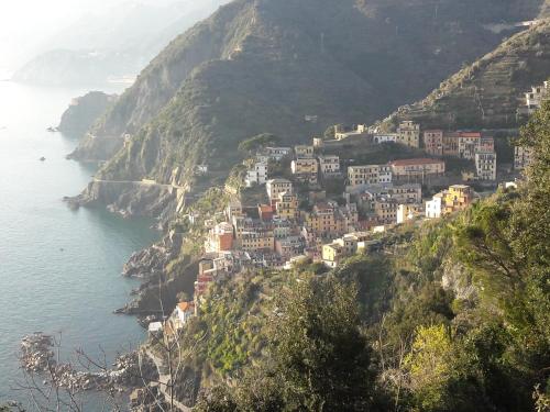 a village on a hill next to the ocean at B&B Oasi Verde in Corvara