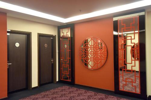 a hallway with doors and a mirror on the wall at Jindagu Hotel Ipoh in Ipoh