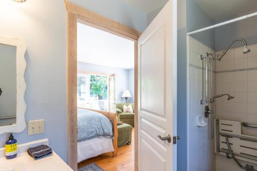 a bathroom with a shower and a bedroom with a bed at Aurora Park Cottages in Calistoga