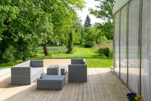 a patio with two couches and a table and chairs at Mazurski Dwór in Olecko