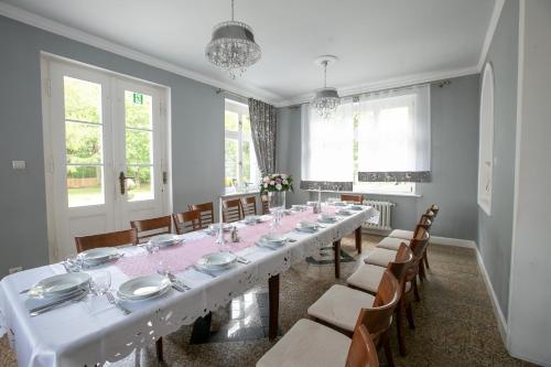 a large dining room with a long table and chairs at Mazurski Dwór in Olecko