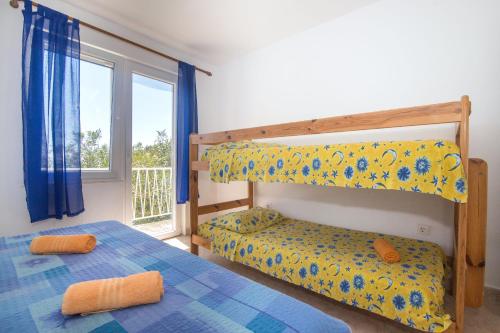 a bedroom with two bunk beds and a window at Apartments Robinzon Petar in Gdinj