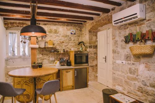 a kitchen with a table and a stove top oven at 5 minutes walk ART in Split