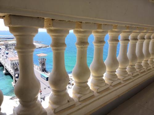 a balcony with a view of the ocean at Stanley Bridge Apartment in Alexandria
