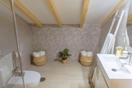 a bathroom with a toilet and a sink at Living Coimbra Corpo de Deus in Coimbra