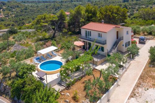 an aerial view of a house with a swimming pool at Villa Ante - with pool in Rogač