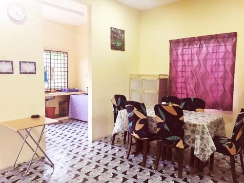 a dining room with a table and chairs at Homestay Bandar Pekan - musleem preferred in Pekan