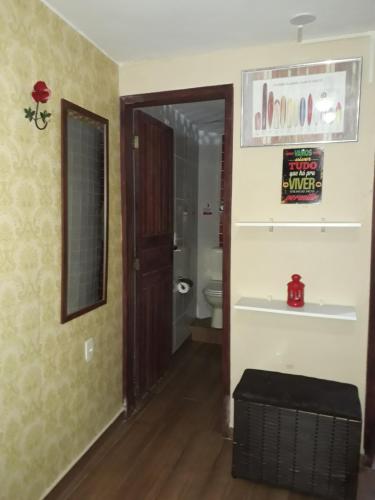 an empty bathroom with a toilet and a door at Paz e Amor Suite in Abraão