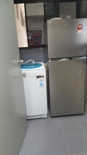 two refrigerators sitting next to each other in a kitchen at TINGKAT 21/10, PANGSAPURI LADANG TOK PELAM in Kuala Terengganu