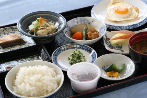 a tray of food with rice and other dishes at Crown Hotel Okinawa in Okinawa City
