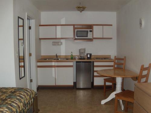 a kitchen with a table and chairs and a refrigerator at Corral Creek Lodge in Kernville