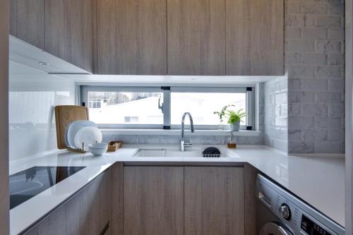 a kitchen with a sink and a window at RGB Stay Life in Tainan