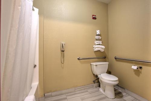a bathroom with a toilet and a shower at Super 8 by Wyndham Waterloo in Waterloo