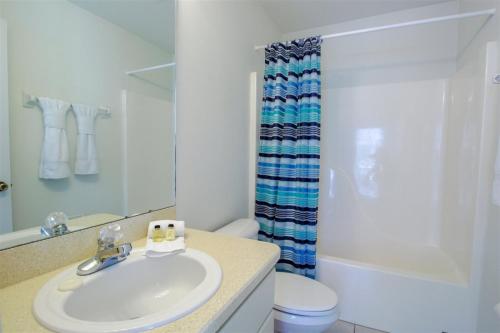 a bathroom with a sink and a toilet and a shower at Luxury 2BR-3BA Pool Villa and 20 Min to WEC- Ocala in Inverness