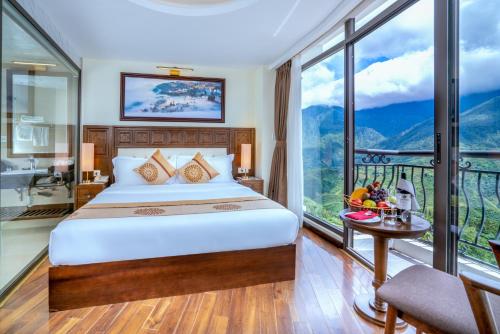 a bedroom with a bed and a large window at Sapa Relax Hotel & Spa in Sa Pa