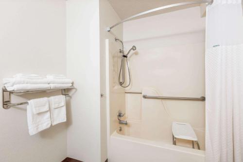 a white bathroom with a shower and a toilet at Super 8 by Wyndham Storm Lake in Storm Lake