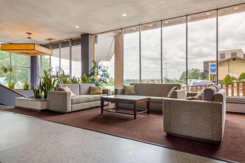 a lobby with couches and a table and large windows at Inn at the Highland Denver Downtown in Denver