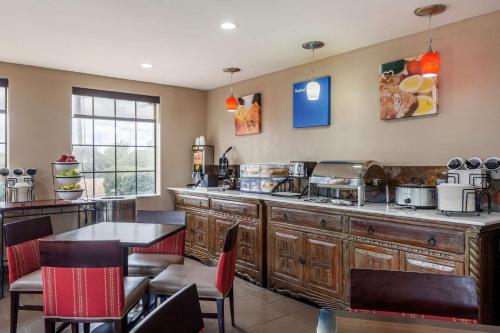 a kitchen with a counter and a table and chairs at Comfort Inn in Santa Fe