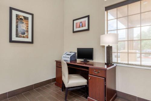 a room with a desk with a computer and a lamp at Comfort Inn in Santa Fe