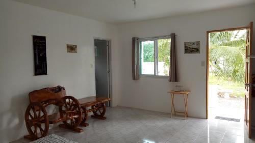 a room with a chair and a table and a window at Kathleens Vacation Place in Moalboal