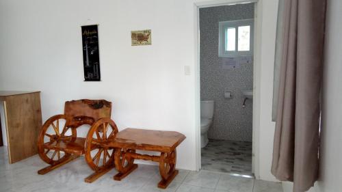 a room with a chair and a wooden wheel in it at Kathleens Vacation Place in Moalboal