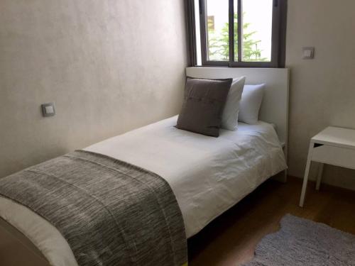 Ένα ή περισσότερα κρεβάτια σε δωμάτιο στο Appartement près de Novotel face au parc WELCOME STAY