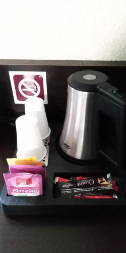 a shelf with a coffee maker and other items on it at B&B HOTEL Le Tréport Friville in Friville-Escarbotin