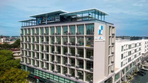 a tall building with a sign on top of it at AZ Hotel & Serviced Apartments in Labuan